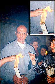 Russian pilgrims bathing with the holy fire that doesn't hurt. Another picture here.